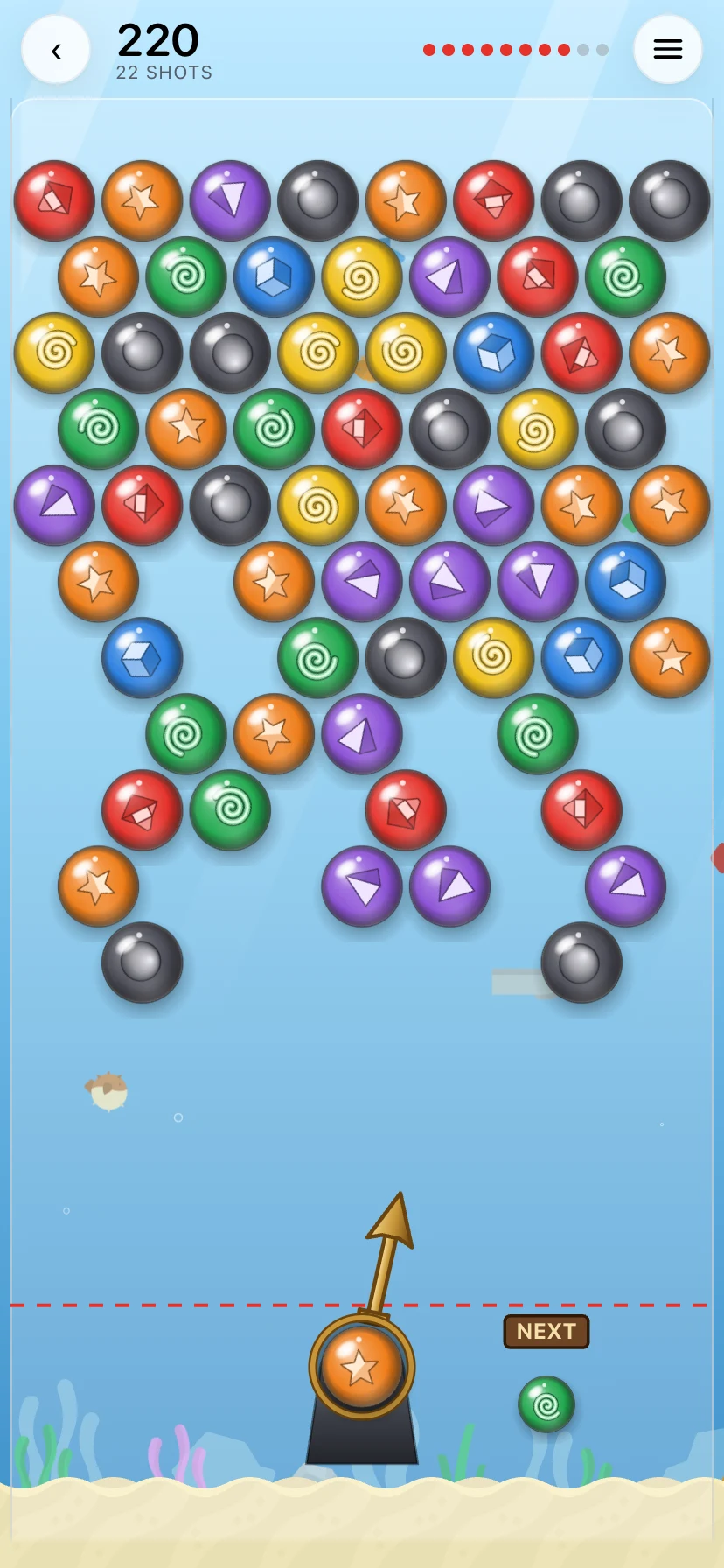Bubbles: a board of glass marbles hanging from the ceiling of a tank in the sea, twenty shots in, the launcher aimed at a bank shot off the wall